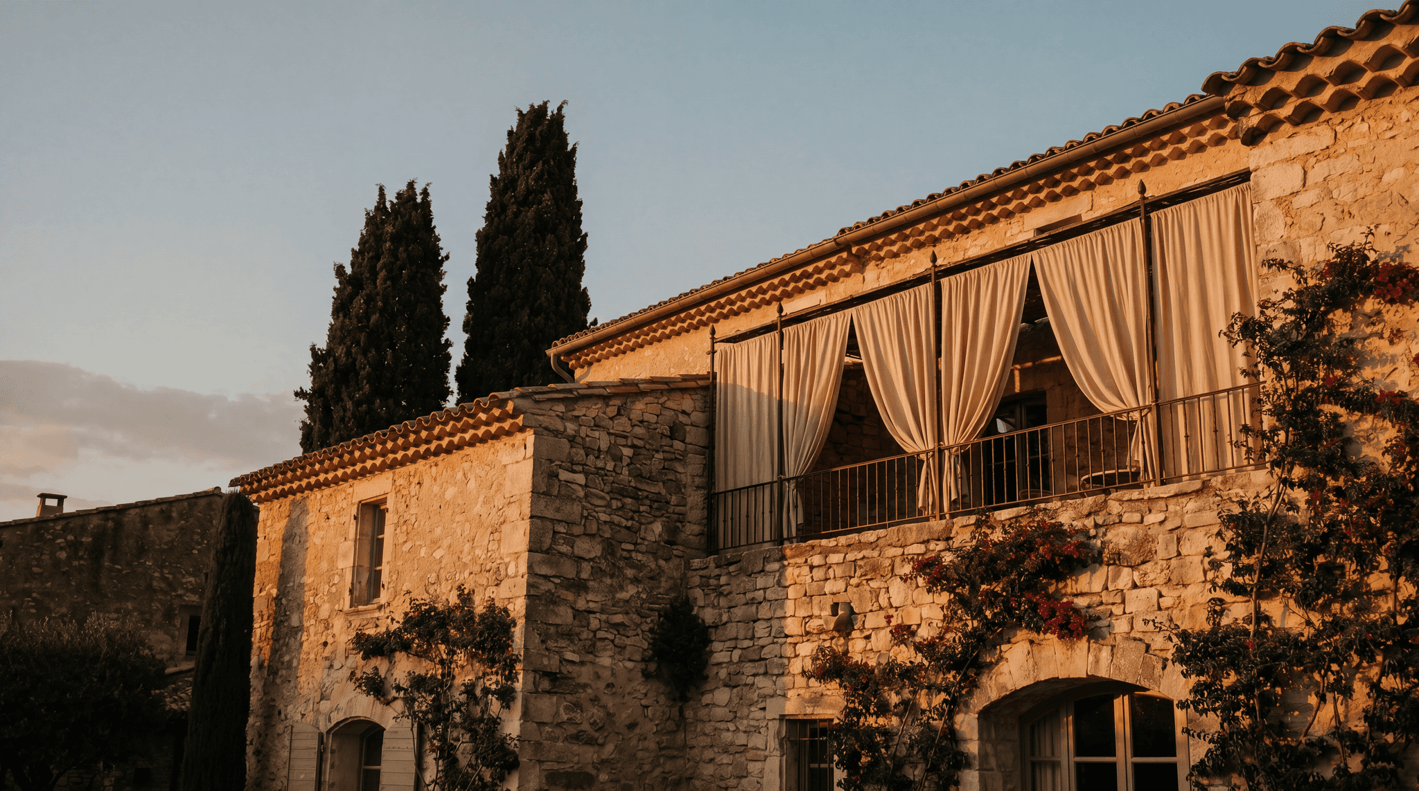 Stone facade of a Mediterranean boutique hotel at golden hour